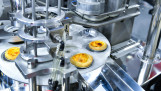 Automatische productielijn voor de productie van eiertaartjes in een bakkerij.